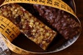 Tasty chocolate bars and peanut brittle with a measuring tape