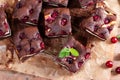 Tasty chocolate brownie with cherry. Pieces of cake on wooden table