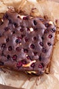 Tasty chocolate brownie with cherry. Pieces of cake on wooden table