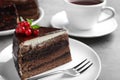 Tasty chocolate cake with berries on grey table Royalty Free Stock Photo