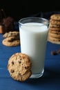 Tasty chocolate chip cookies and glass of milk on blue wooden table Royalty Free Stock Photo