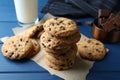 Tasty chocolate chip cookies and glass of milk on blue wooden table, closeup Royalty Free Stock Photo