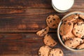 Tasty chocolate chip cookies and glass of milk on wooden table, top view Royalty Free Stock Photo