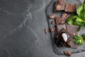 Tasty chocolate pieces with syrup and mint on black table, flat lay. Space for text Royalty Free Stock Photo