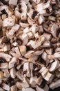 Tasty chopped champignon mushrooms texture, uncooked food sliced, dark brown wooden background