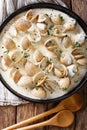 Tasty clams in a creamy sauce with garlic and greens close-up on Royalty Free Stock Photo