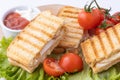 Tasty club sandwiches with ham and cheese on wooden table. Grilled and pressed toast with smoked ham, cheese, tomato and lettuce