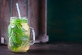Tasty colorful drink with cold green tea, mint and cucumber in a glass jar on a vintage background Royalty Free Stock Photo
