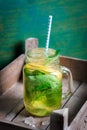 Tasty colorful drink with cold green tea, mint and lemon in a glass jar on a vintage background Royalty Free Stock Photo