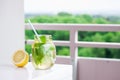 Tasty colorful drink with cold green tea, mint and lemon in a glass jar on a white kitchen background Royalty Free Stock Photo