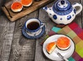 Tasty and colorful jelly cake on wooden table with cup of tea. Orange Cheescake Royalty Free Stock Photo