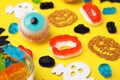 Tasty colorful jelly candies and Halloween decorations on yellow background, closeup Royalty Free Stock Photo