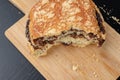 Tasty cookie broken in half. Fresh bread on a kitchen board Royalty Free Stock Photo