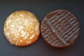 Delicious cookies with and without chocolate over black background.