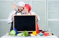 Tasty cooking class. Couple of man and woman giving ok sign at blackboard in cooking school. Master cook and prep cook