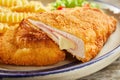 Tasty cordon bleu with cheese on plate