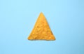 Tasty corn chip on color background