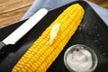 Tasty corn cob with butter and salt on plate, closeup Royalty Free Stock Photo