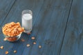 Tasty corn flakes in bowl with glass of milk Royalty Free Stock Photo