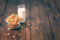 Tasty corn flakes in bowl with glass of milk Royalty Free Stock Photo