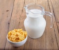 Tasty cornflakes in white bowl and glass of milk Royalty Free Stock Photo