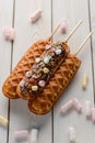 Tasty cornmeal dessert sticks on wooden background