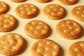 Tasty cracker biscuits on beige background, close up