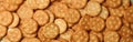 Tasty cracker biscuits on whole background, top view