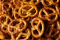 Tasty cracker pretzels on whole background, close up