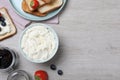 Tasty cream cheese, toasted bread and fresh berries on white wooden table, flat lay. Space for text Royalty Free Stock Photo