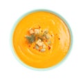 Tasty creamy pumpkin soup in bowl on background, top view
