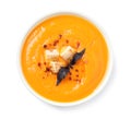 Tasty creamy pumpkin soup in bowl on background, top view