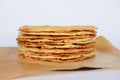 Tasty crispy baked round puff pastry layers of homemade traditional Russian napoleon cake on parchment