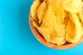 Tasty crispy potato chips in wooden bowl Royalty Free Stock Photo