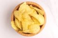 Tasty crispy potato chips in wooden bowl Royalty Free Stock Photo