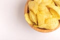 Tasty crispy potato chips in wooden bowl Royalty Free Stock Photo