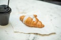 Tasty croissant with a cup of coffee - close up view Royalty Free Stock Photo