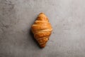 Tasty croissant on grey , top view. French pastry
