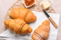 Tasty croissants with jam and butter on grey background Royalty Free Stock Photo