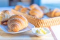 Tasty croissants with spikelets on wooden background; taste of F