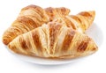 Tasty crusty croissants on the plate on white background