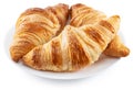 Tasty crusty croissants on the plate on white background. File contains clipping path