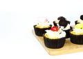 Tasty cup cake on wood board on white backgrounds