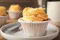 Tasty cupcake with cream served on plate, closeup