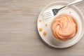 Tasty cupcake served on wooden table, top view. Space for text