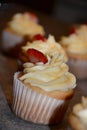 Tasty cupcakes with buttercream and strawberry. Home made cupcakes with vanilla cream Royalty Free Stock Photo