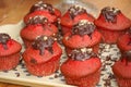 Tasty cupcakes with red cream and chocolate. Royalty Free Stock Photo