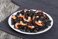 Tasty Cuttlefish ink black noodles with prawns on white dish Royalty Free Stock Photo