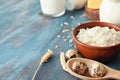 Tasty dairy products with quail eggs on color wooden table