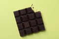 Tasty dark chocolate bar with bite mark on background, top view Royalty Free Stock Photo